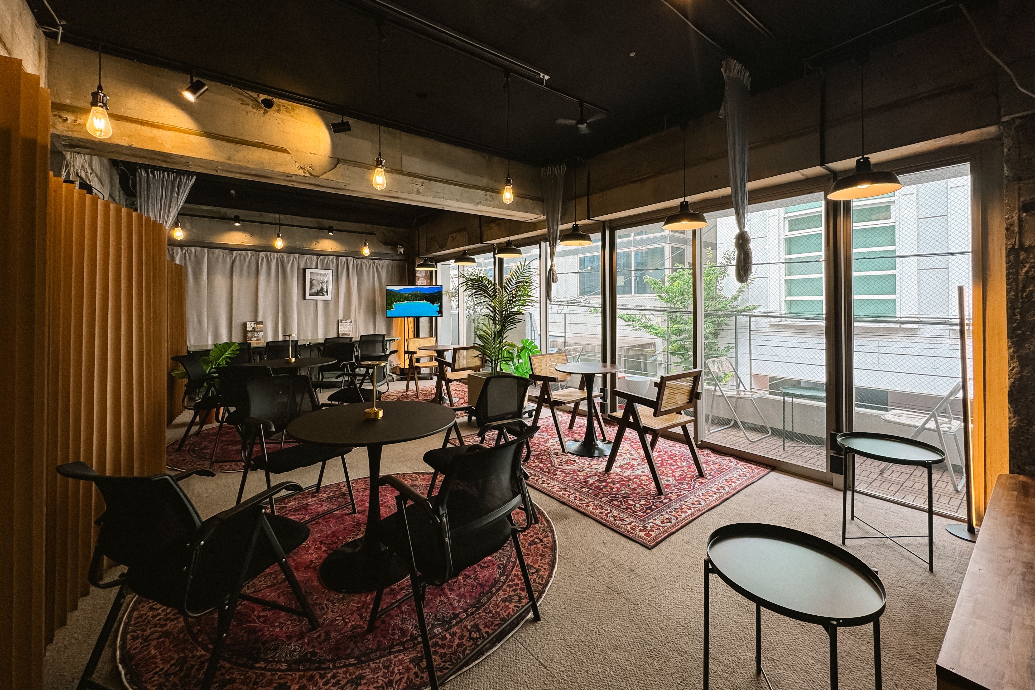 Lounge area with rugs, cafe tables, and balcony seating