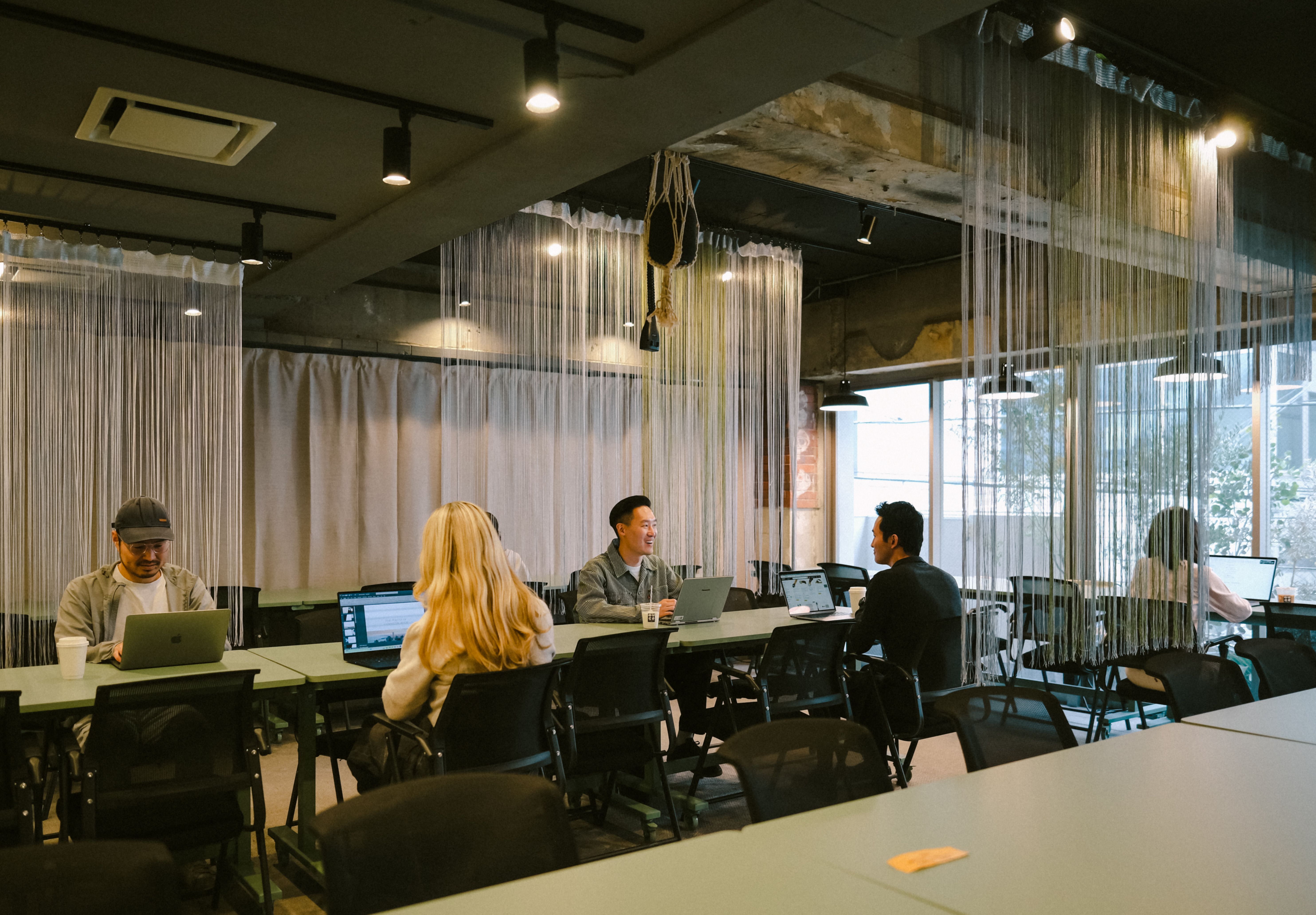 Members working and talking in the shared office area