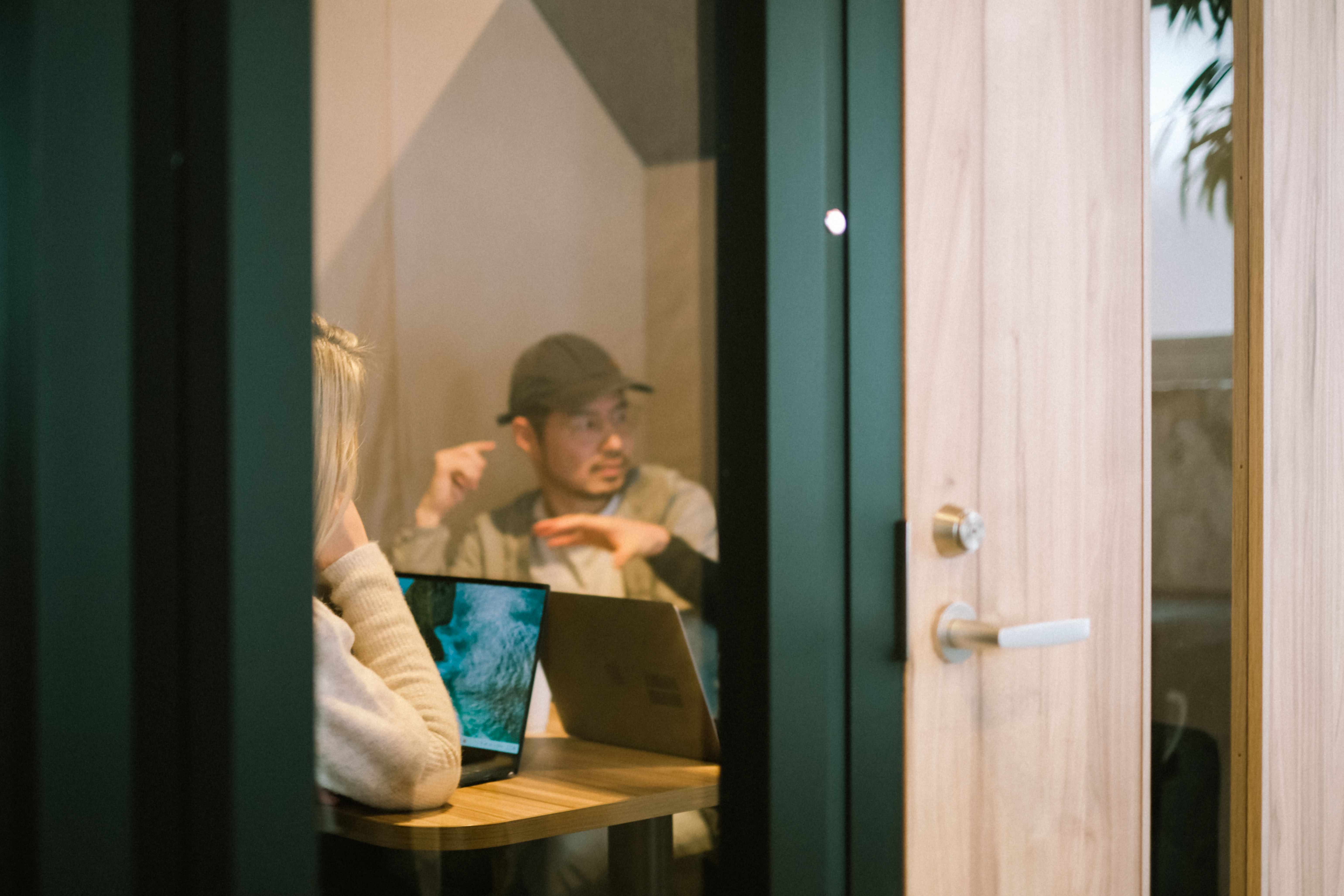 Meeting room conversation seen through the doorway